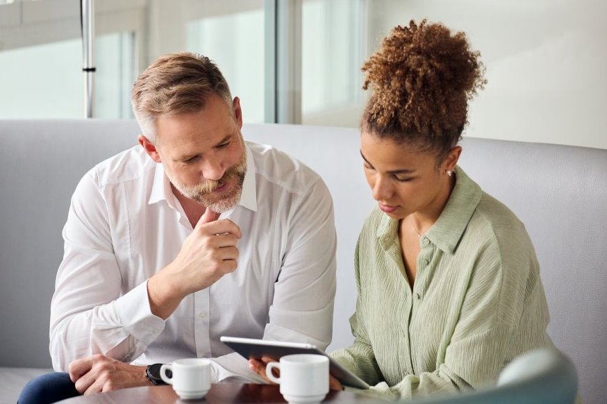 Woman and man looking at tablet